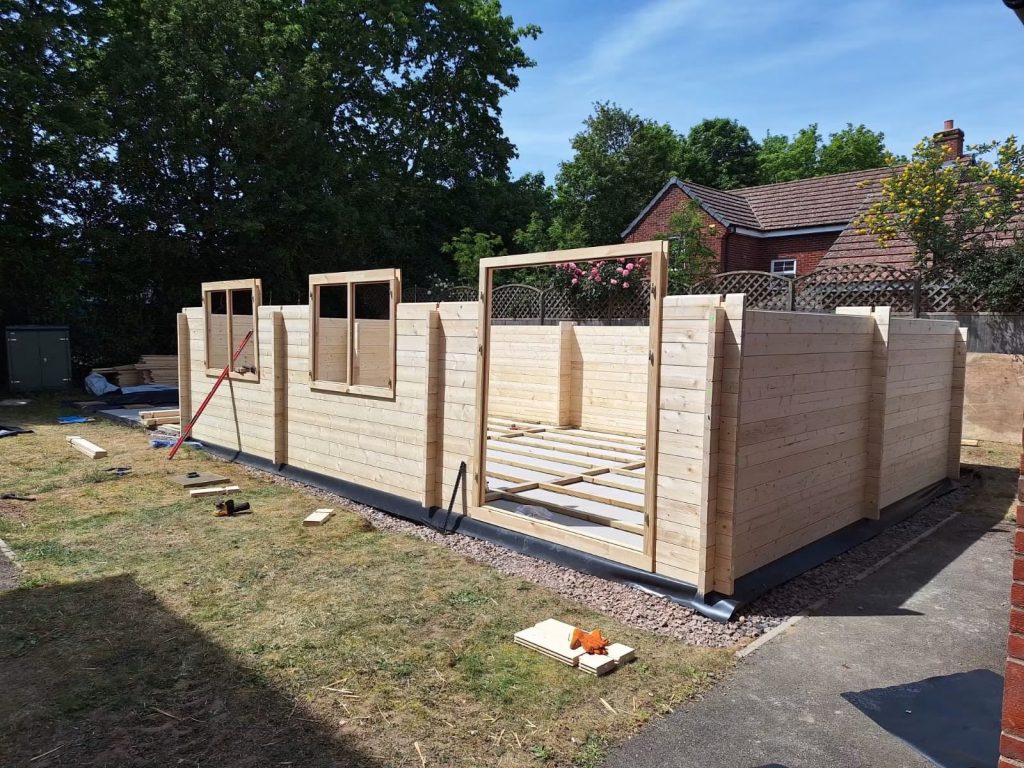 A half built workshop shed with window frames in place
