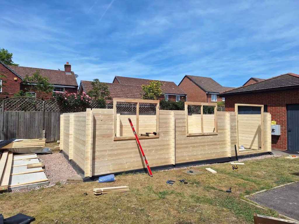 A half built workshop shed with window frames in place